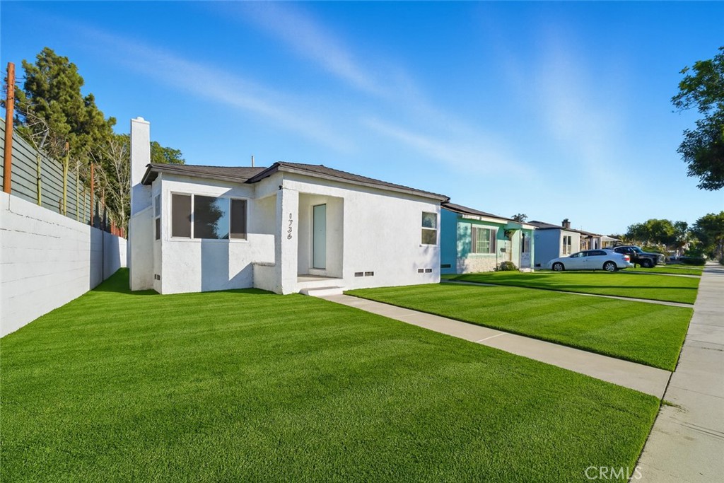 1736 North McDivitt Avenue Compton, CA 90221 - Photo 2 of 30 a view of a big house with a big yard and large trees
