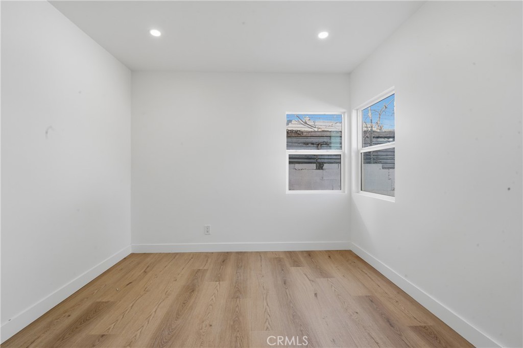 1736 North McDivitt Avenue Compton, CA 90221 - Photo 22 of 30 wooden floor in an empty room with a window