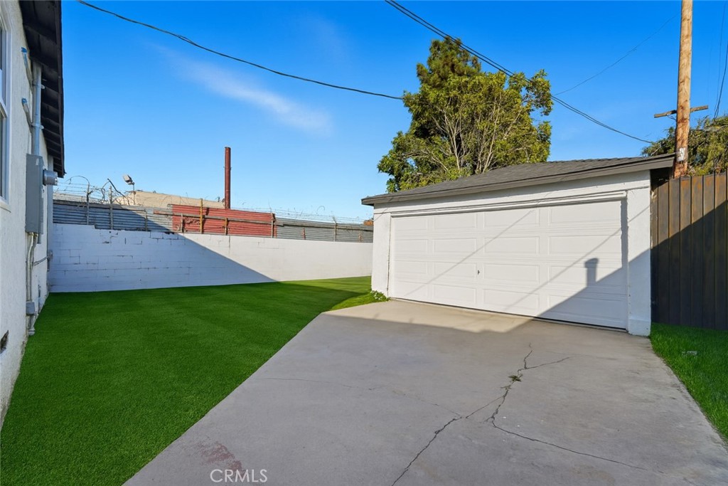 1736 North McDivitt Avenue Compton, CA 90221 - Photo 27 of 30 a view of a house with a yard and a garage