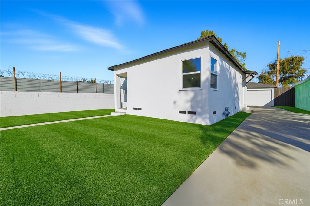 1736 North McDivitt Avenue Compton, CA 90221 - Photo 4 of 30 a front view of a house with a yard