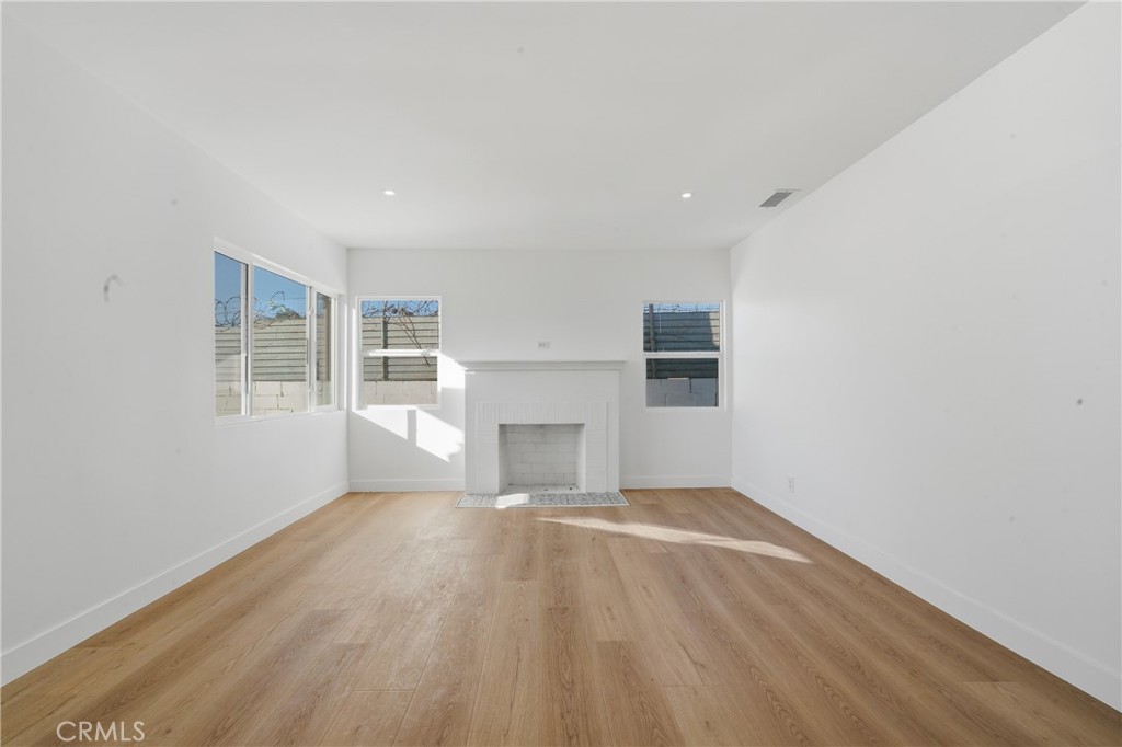1736 North McDivitt Avenue Compton, CA 90221 - Photo 5 of 30 an empty room with windows and fireplace
