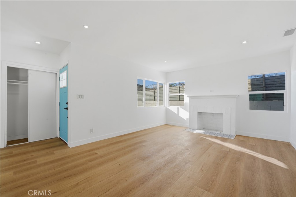 1736 North McDivitt Avenue Compton, CA 90221 - Photo 6 of 30 an empty room with wooden floor and windows