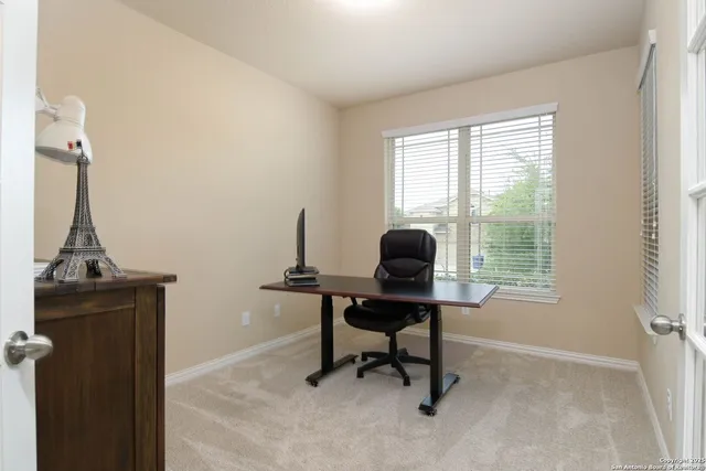 a living room with furniture and a ceiling fan