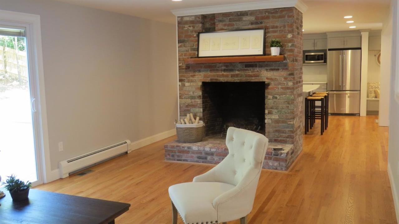 163 Fuller Road Centerville, MA 02632 - Photo 12 of 23 a living room with furniture wooden floor and a fireplace