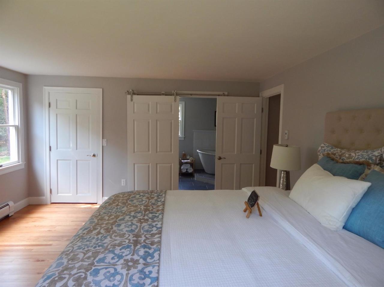 163 Fuller Road Centerville, MA 02632 - Photo 16 of 23 a bedroom with a bed and a large mirror