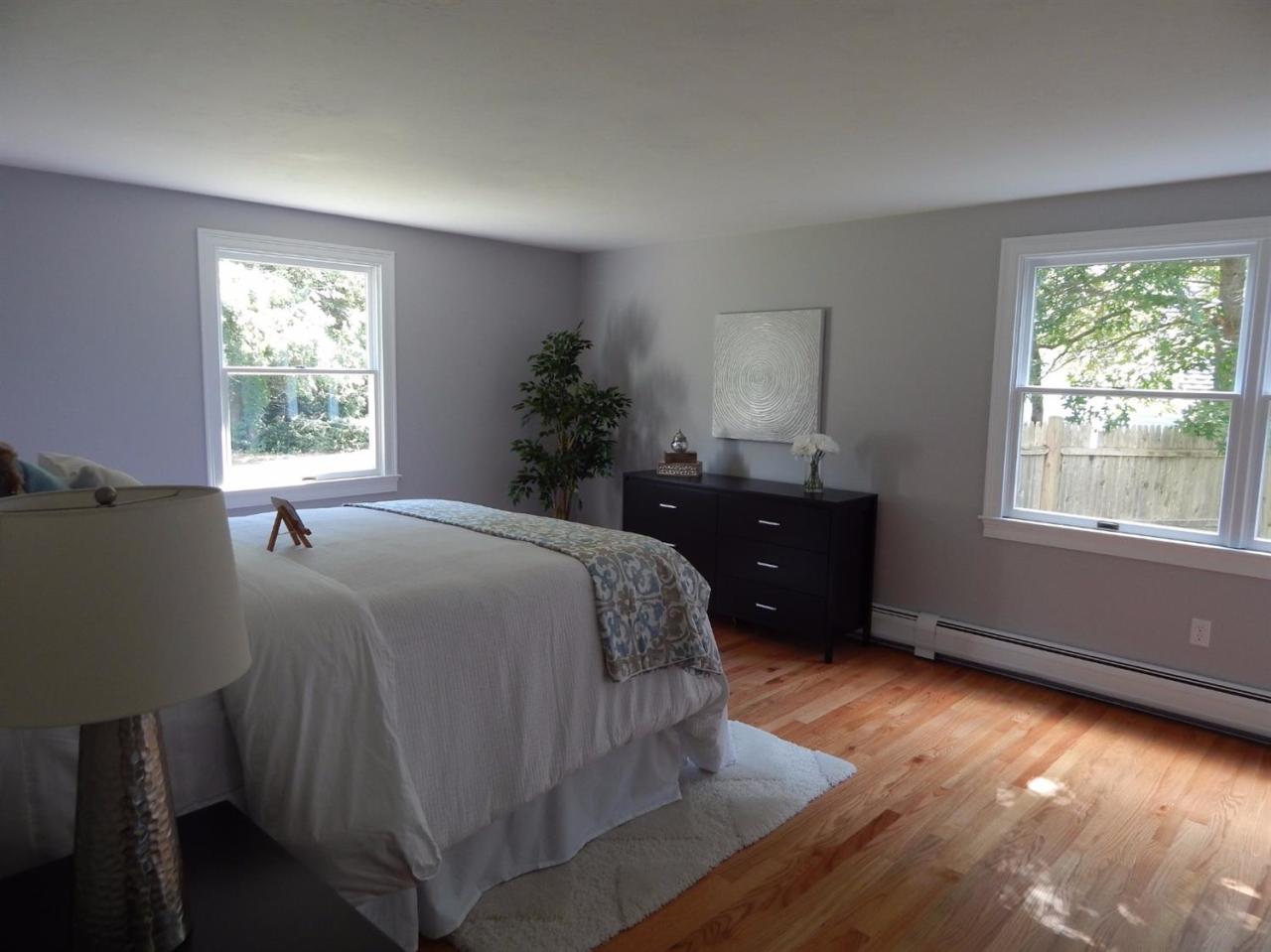163 Fuller Road Centerville, MA 02632 - Photo 18 of 23 a bed sitting in a bedroom next to a window