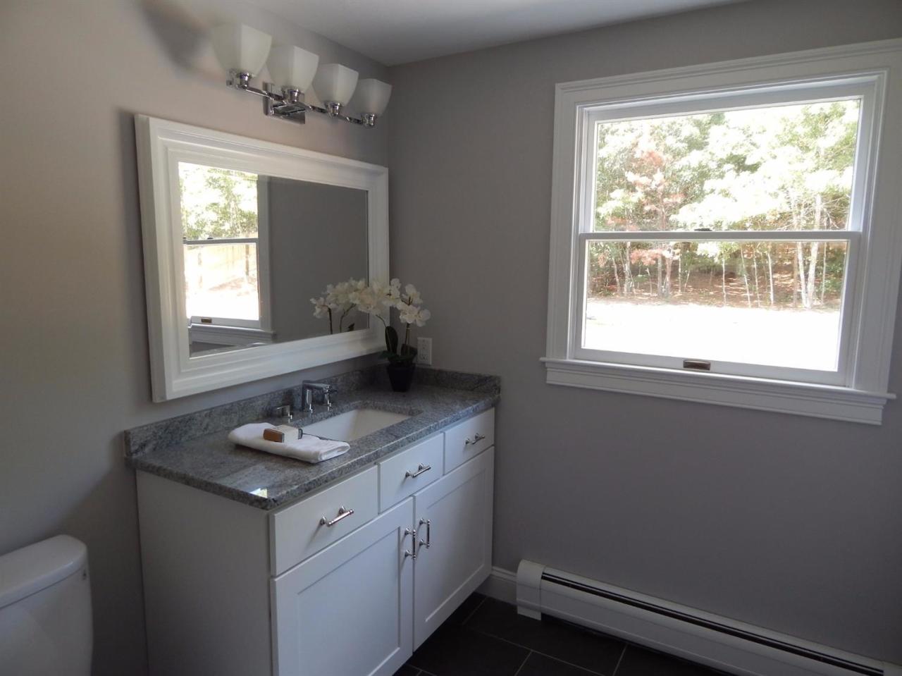 163 Fuller Road Centerville, MA 02632 - Photo 19 of 23 a bathroom with a granite countertop sink window and a mirror