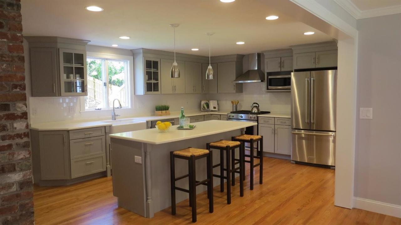 163 Fuller Road Centerville, MA 02632 - Photo 6 of 23 a kitchen with stainless steel appliances granite countertop a table chairs sink refrigerator and microwave