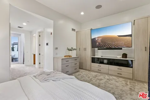 a bedroom with a bed and a dresser