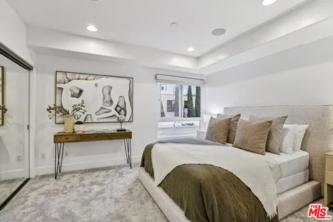 a bedroom with a large bed and a couch