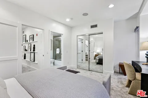 a bedroom with furniture and a book shelf