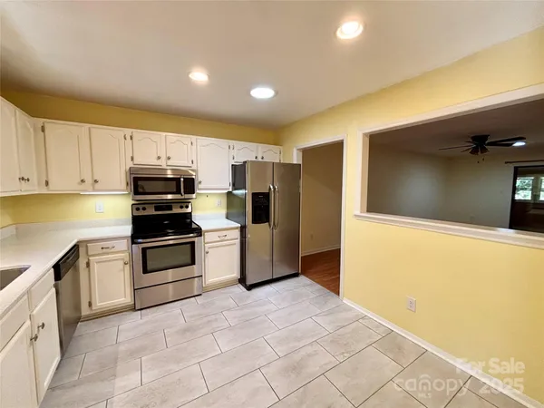 a kitchen with stainless steel appliances a refrigerator and a stove