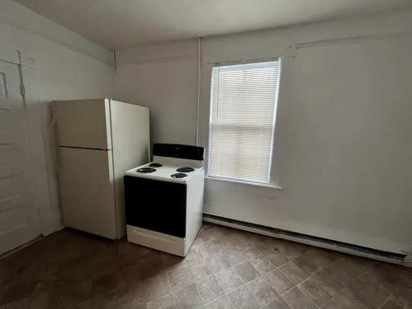 a kitchen with a refrigerator and a stove