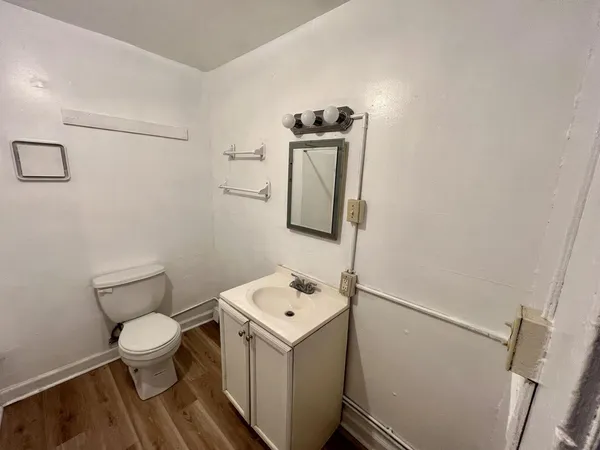 a white toilet sitting next to a bathroom sink