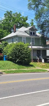 a front view of house with a garden