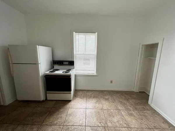 a view of kitchen with refrigerator and microwave