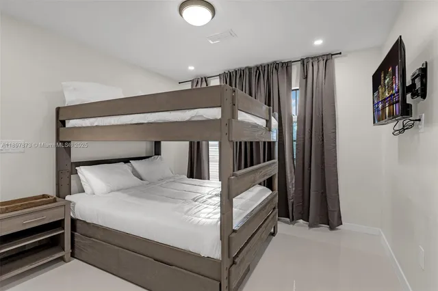 a large white bed in a white room