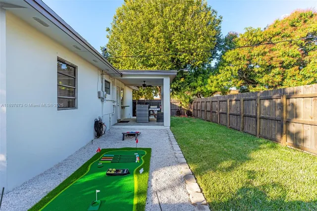 a backyard of a house table and chairs