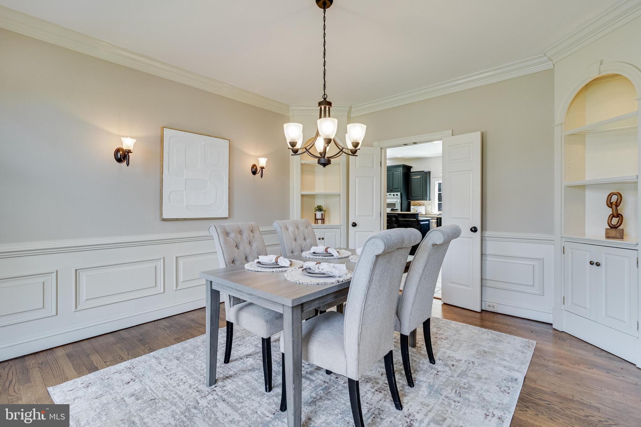 99 Hummingbird Court Dunkirk, MD 20754 - Photo 11 of 84 a dining room with wooden floor a chandelier a wooden table and chairs