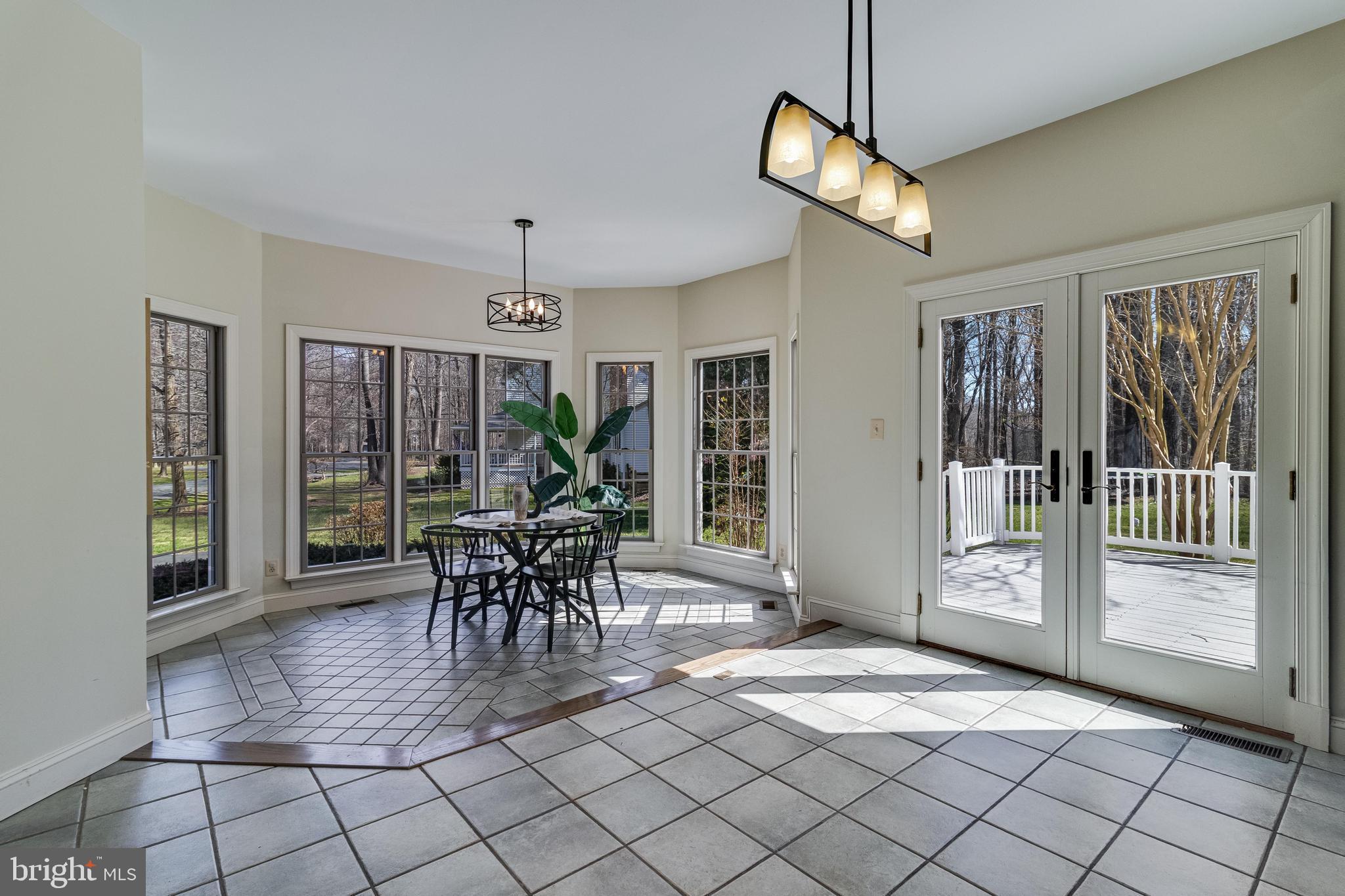 99 Hummingbird Court Dunkirk, MD 20754 - Photo 19 of 84 a dining room with furniture chandelier and glass door