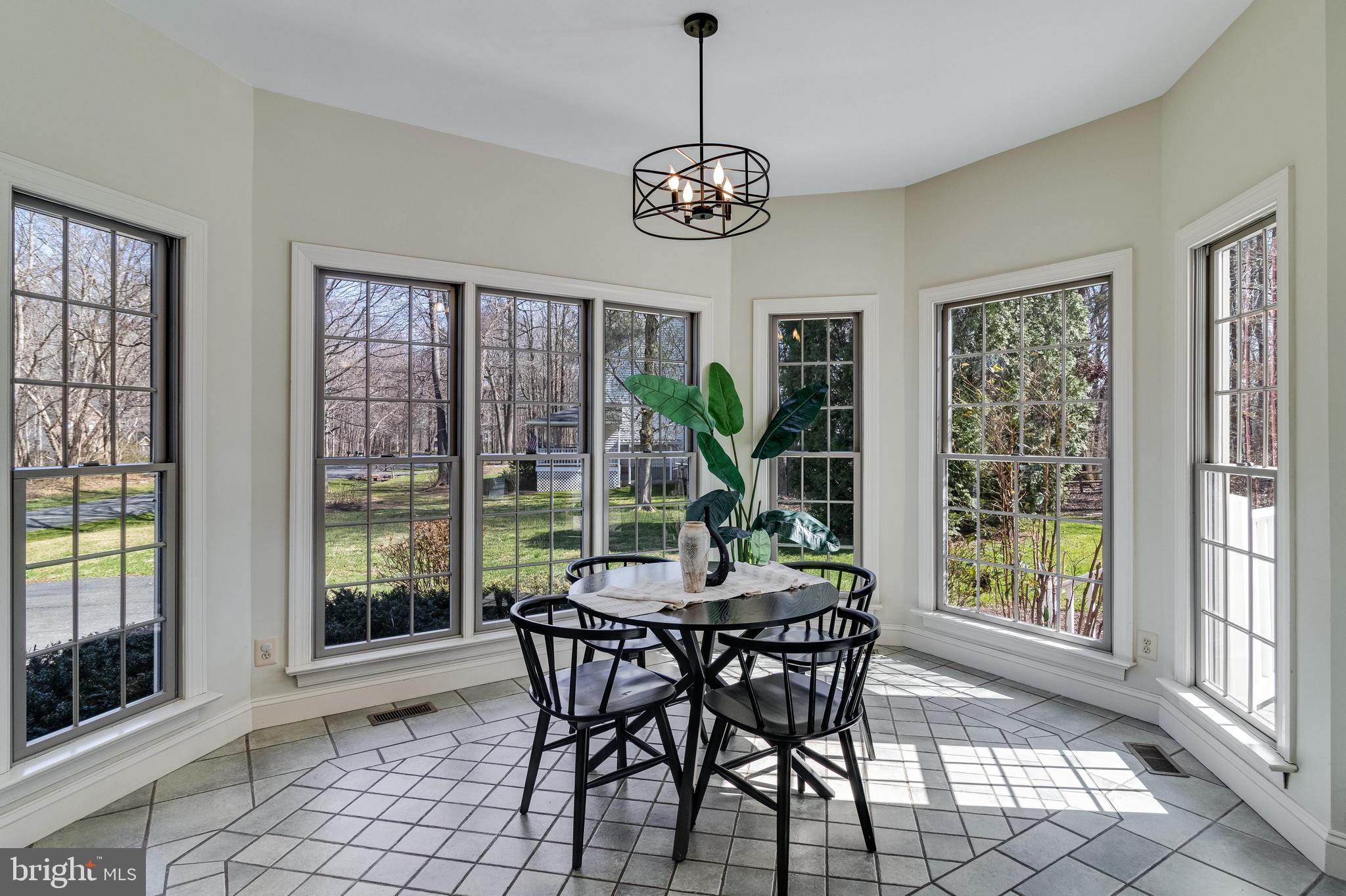 99 Hummingbird Court Dunkirk, MD 20754 - Photo 20 of 84 a dining room with furniture a chandelier and wooden floor