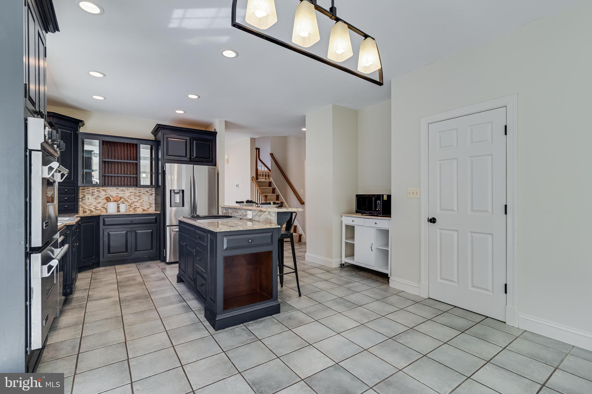 99 Hummingbird Court Dunkirk, MD 20754 - Photo 23 of 84 a kitchen with stainless steel appliances a refrigerator and a stove