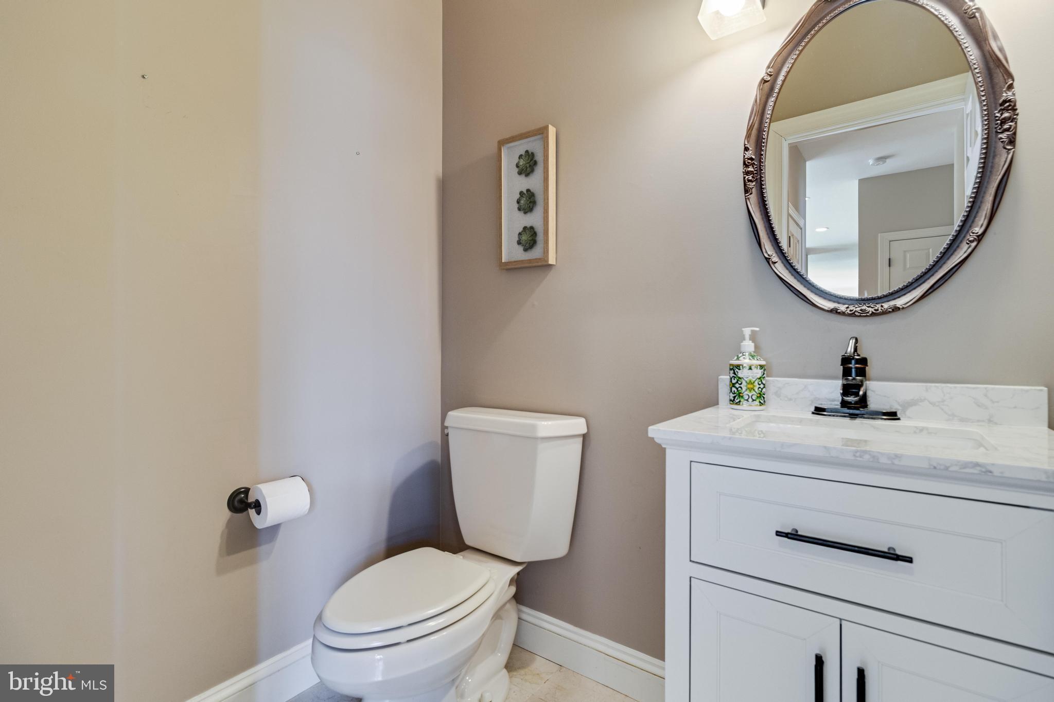 99 Hummingbird Court Dunkirk, MD 20754 - Photo 25 of 84 a bathroom with a toilet a sink and a mirror