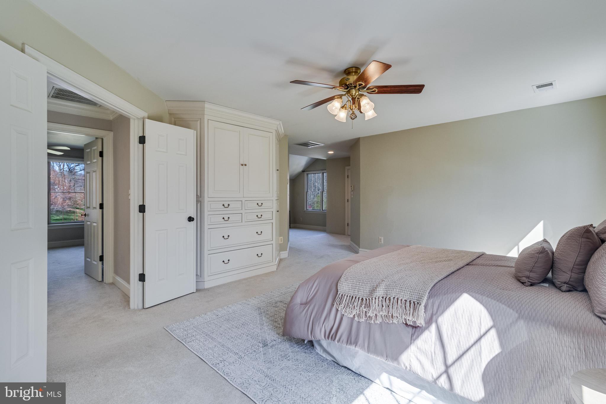 99 Hummingbird Court Dunkirk, MD 20754 - Photo 31 of 84 a bedroom with a bed and a chandelier