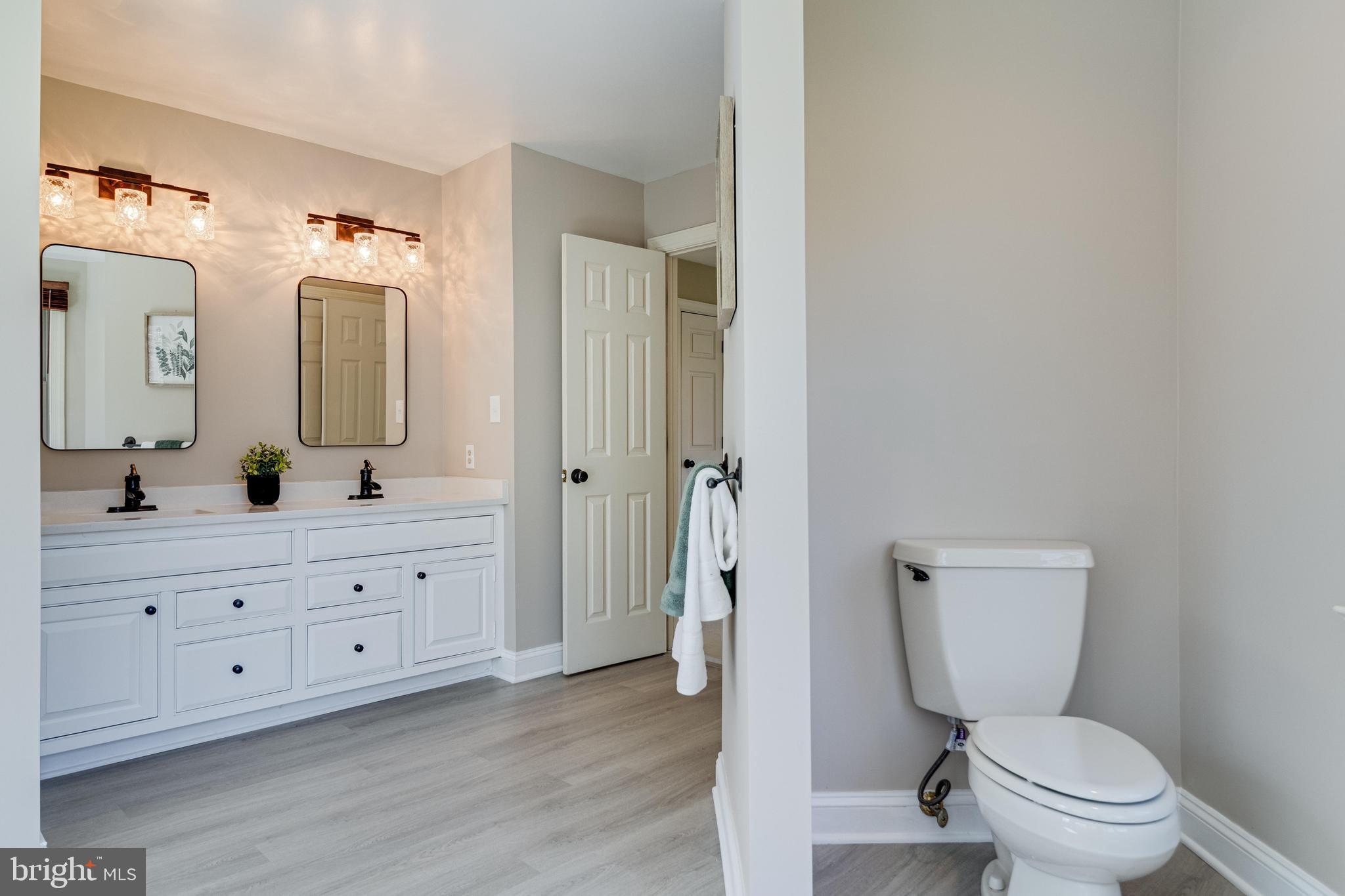 99 Hummingbird Court Dunkirk, MD 20754 - Photo 36 of 84 a bathroom with a toilet a sink and a mirror
