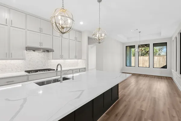 an empty room with a window and a ceiling fan