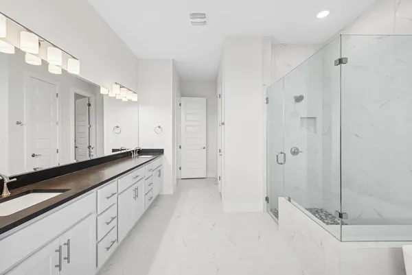 a bathroom with a granite countertop sink a toilet and mirror