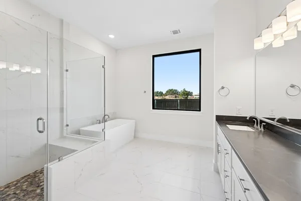 a view of an empty room with window and mirror