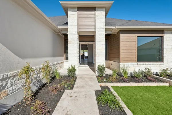 a front view of a house with garden