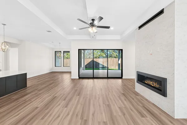 a view of a livingroom with wooden floor and a ceiling fan