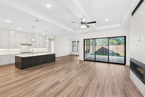 a view of a kitchen with wooden floor and a window