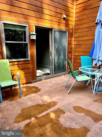 a view of a room with table and chairs