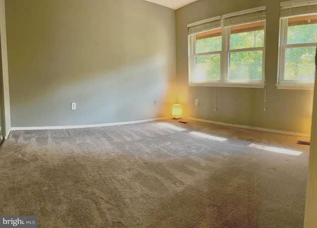 an empty room with a empty space and a window