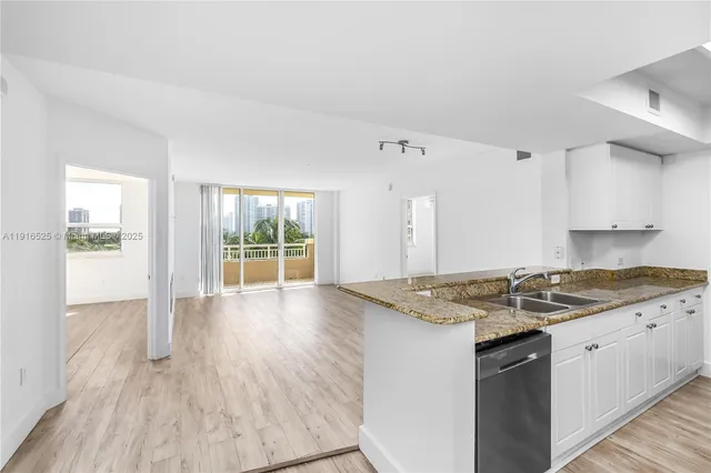 a view of kitchen with wooden floor and outdoor space