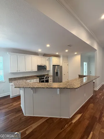 a view of kitchen with granite countertop window