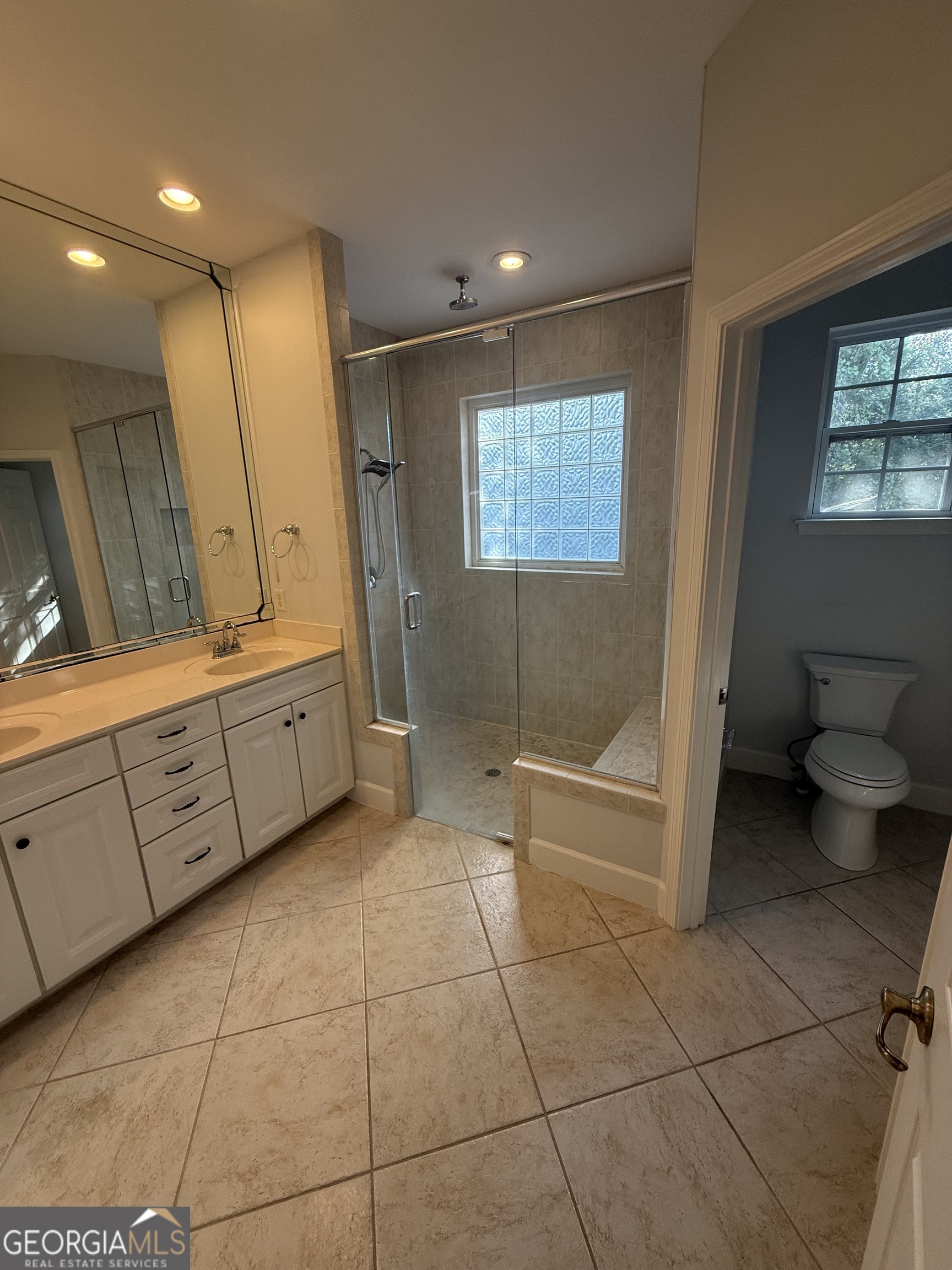 1603 Sandpiper Court St. Marys, GA 31558 - Photo 20 of 33 a bathroom with a granite countertop sink a toilet and mirror