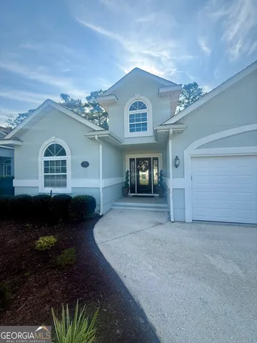 a view of a house with a yard and plants