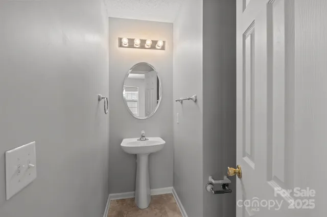 a view of a bathroom with a sink and mirror