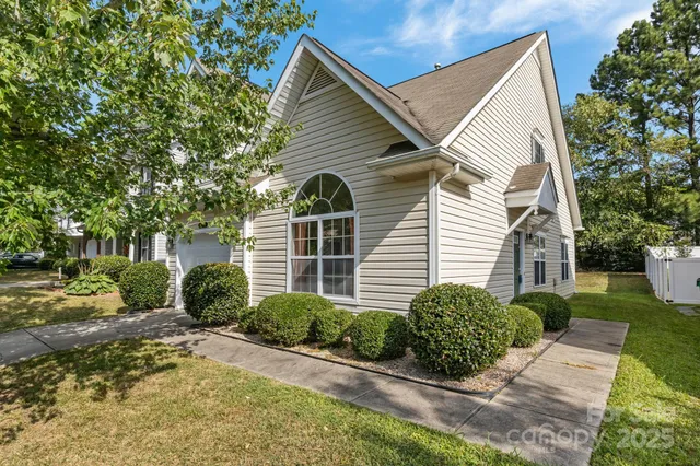 a front view of a house with yard and glass windows