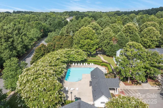 an aerial view of a house with a yard and lake view