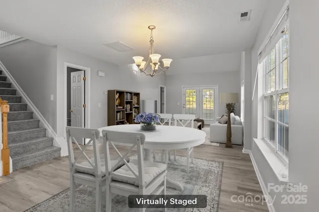 a view of a dining room with furniture and a chandelier