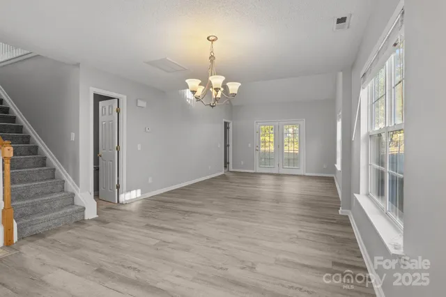 a view of an entryway with wooden floor