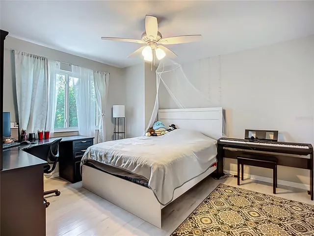 a bedroom with a bed and a chandelier