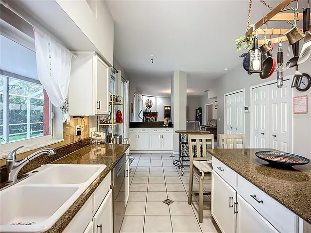 a kitchen with stainless steel appliances granite countertop a sink and a stove