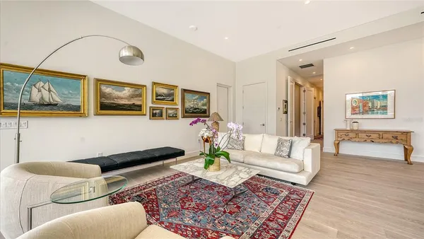 a kitchen with stainless steel appliances kitchen island granite countertop a stove a sink a dining table and chairs