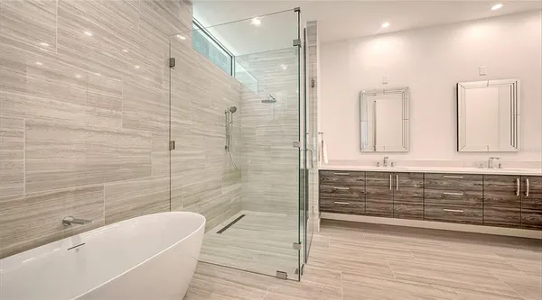 a spacious bedroom with a bed and dresser